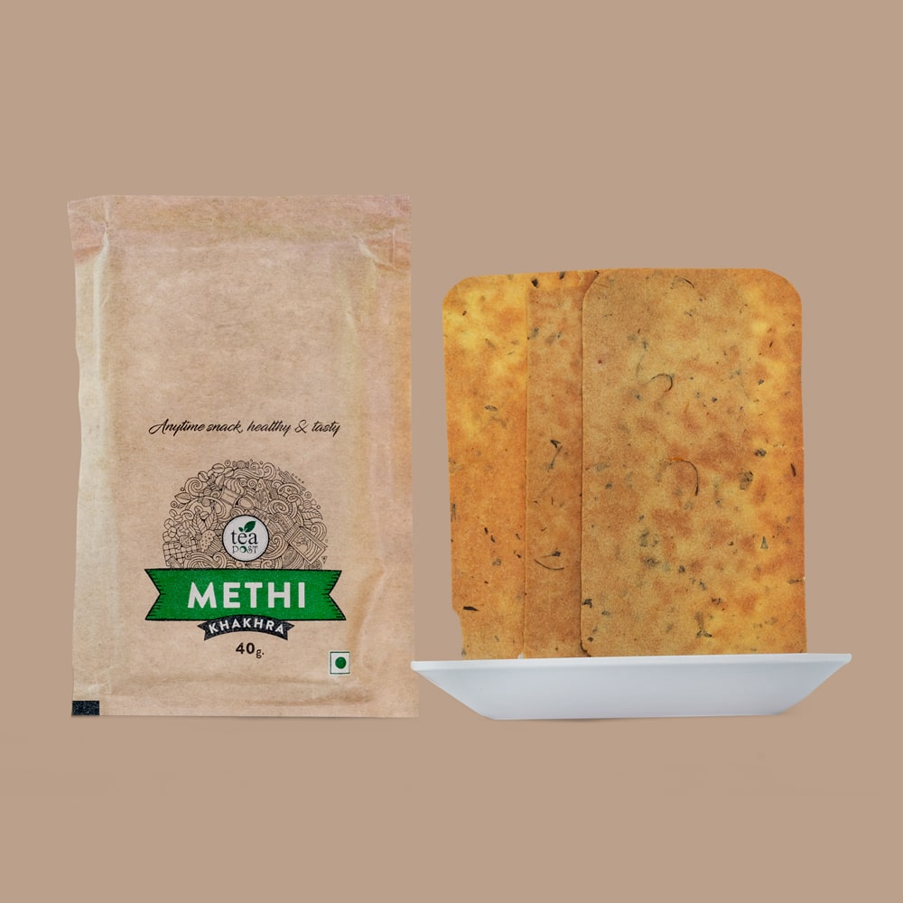 A packet of Methi khakhra and three units of Methi khakhra on the plate.